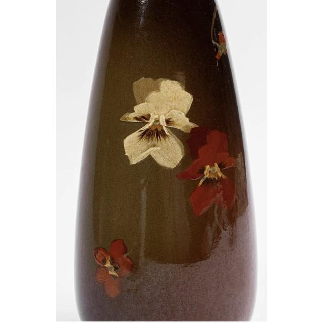 An early 20th-century (circa 1900-1919) J.B. Owens Utopian art pottery vase, faintly stamped "OWENS 013" to the bottom....