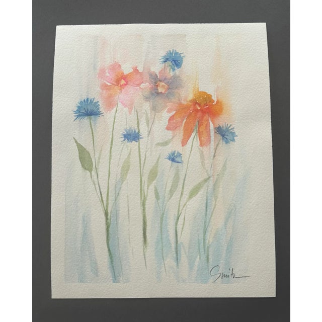 Capture the gentle beauty of nature with this soft and serene watercolor painting featuring vibrant orange and pink blooms...