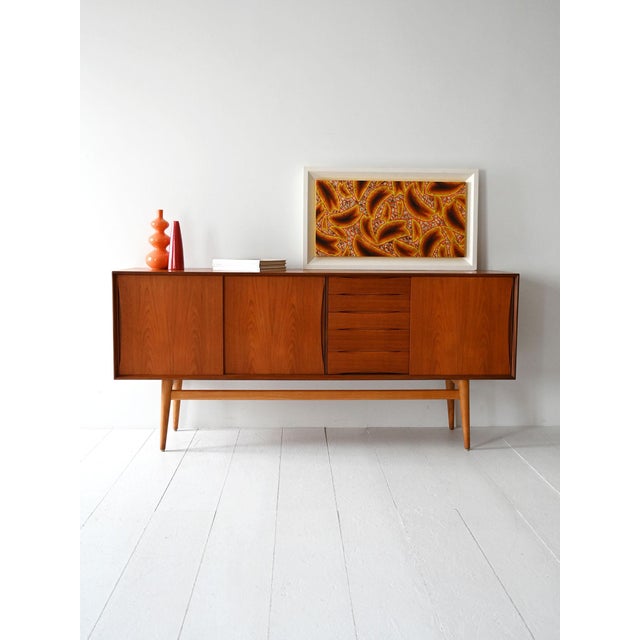 Teak sideboard from the 60s with sliding doors and drawers with integrated groove handle. Original Scandinavian sideboard...