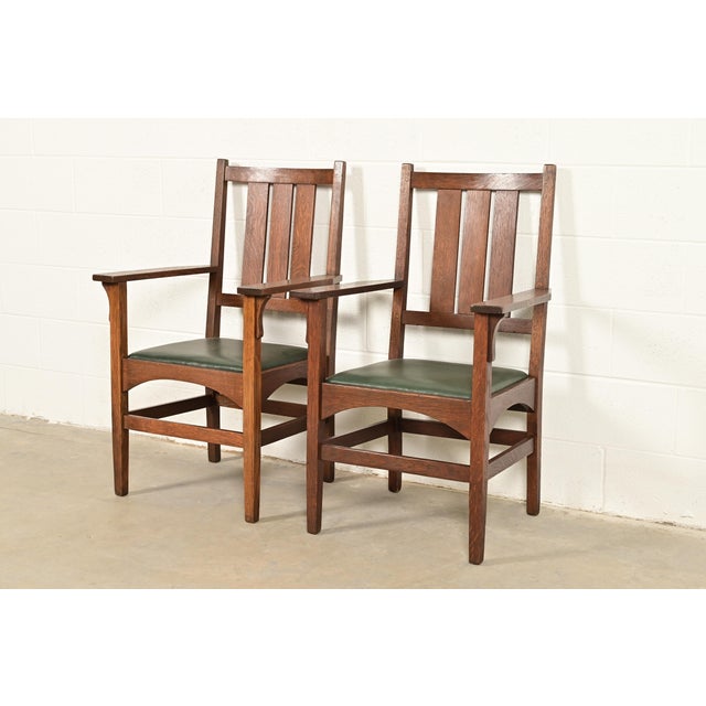 A rare and exceptional pair of antique Mission or Arts & Crafts period armchairs or dining captain chairs Designed by...