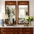 Elegant pair of Federal-style trumeau mirrors featuring rich wood-grain frames and classic Neoclassical urn-and-swag...