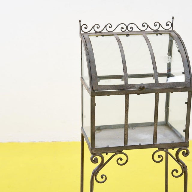 Discover this refined wrought iron display case, a unique design piece that captures the essence of vintage style. With...