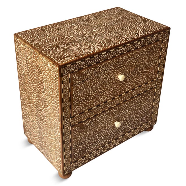 Rich in craftsmanship and timeless character, this vintage Indian teak nightstand showcases an intricate hand-inlaid...