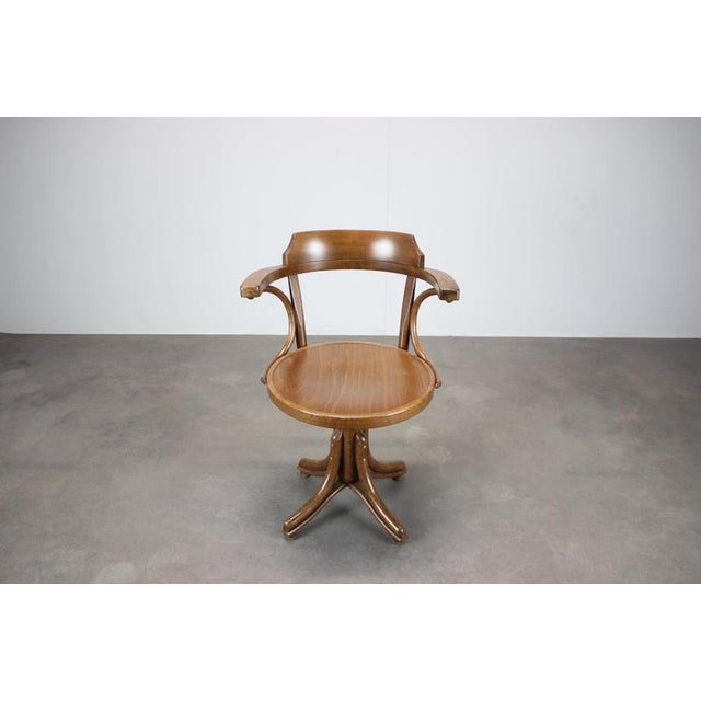 A distinctive 1993 ton bentwood swivel armchair from czechoslovakia, produced by ton a.s. In bystřice pod hostýnem. The...