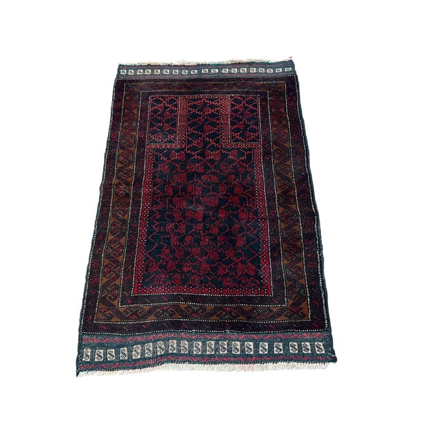Afghan Balouch prayer rug, hand knotted in Afghanistan from 100% wool. Measuring 2’7” x 4’2”, this rug features a...