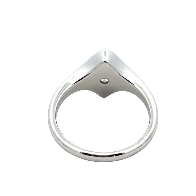 Elegant 18K white gold ring featuring a bezel-set marquise cut diamond weighing 0.87 carats. Ring weight is 4.6 grams....