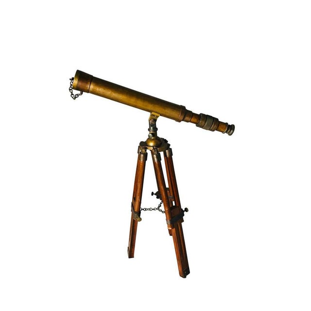 A beautiful 20th century english brass telescope on an adjustable mahogany tripod base. Offered in complete original...