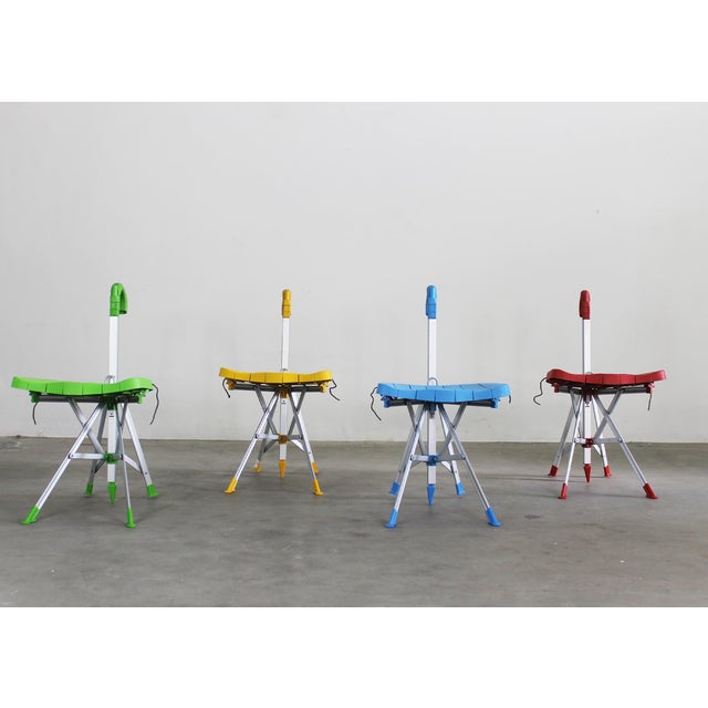 Set of four foldable Umbrella chairs with an aluminum frame, cast resin seat and handle and leather ties designed by...