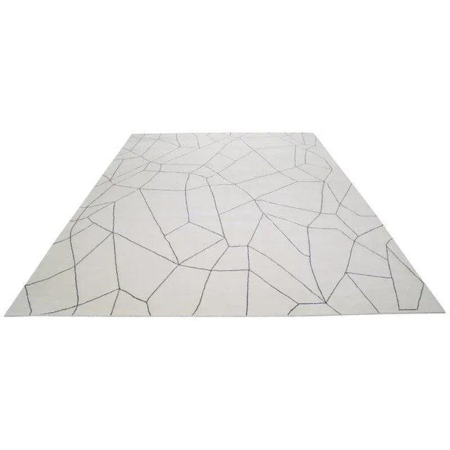 Moroccan hand knotted wool rug with abstract design.