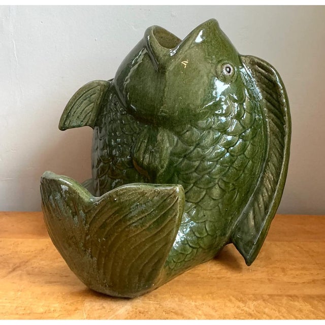 This large-scale sculptural vase takes the dramatic form of an upturned fish, its open mouth serving as the functional...