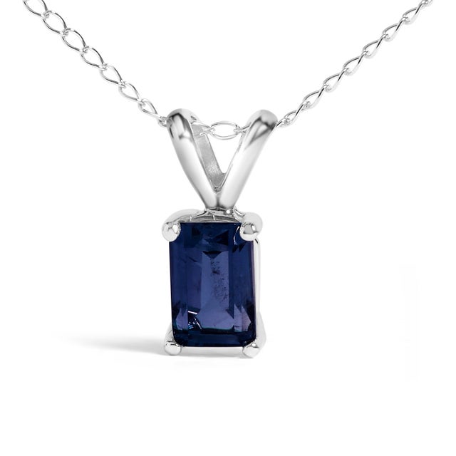 Draped in the regal splendor of a color-enhanced, natural sapphire, this 14K white gold pendant necklace exudes elegance...