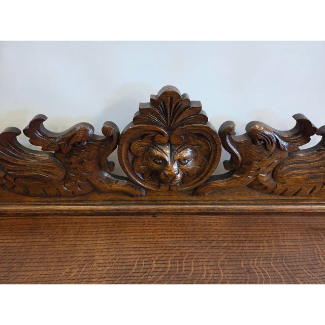 A wonderful 1880s Solid carved oak desk. Lion and crest on back, two drawers for pens pencils and supplies.