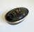 A small sculptural bronze box crafted by Nelles Studio, signed and dated 1989. It features an oval-shape with a serene...