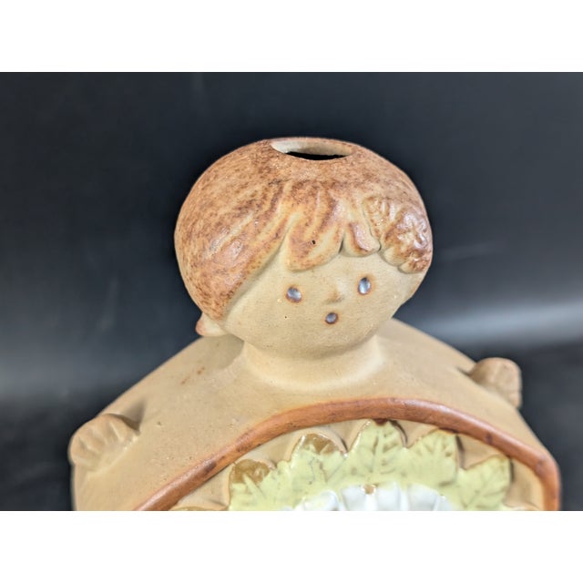 This bud vase stands six inches tall and is in lovely condition. Minor rub marks to the bottom, no chips.
