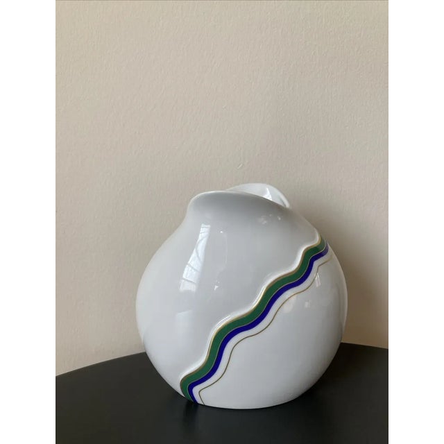 A beautiful German white porcelain vase with geometric design in green, blue, and gold, circa mid 20th century, West...