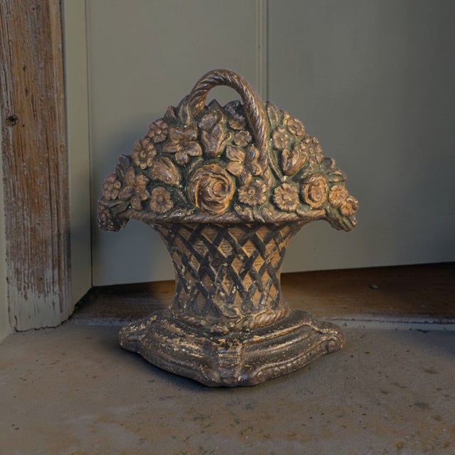 This antique cast iron multi flower basket doorstop is a unique and charming collectible from the United States. Crafted...