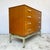 Afrormosia-veneered carcase construction on a painted metal stand base. Four full-width graduated drawers with dovetail...