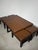Elegant contemporary coffee table set comprising a generously sized coffee table and four matching nesting stools....