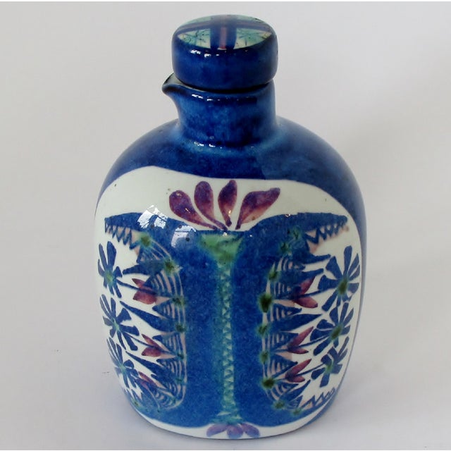1950s Danish faience ceramic bottle by artist Marianne Johansson for Aluminia. The bottle has been finished in blue, green...