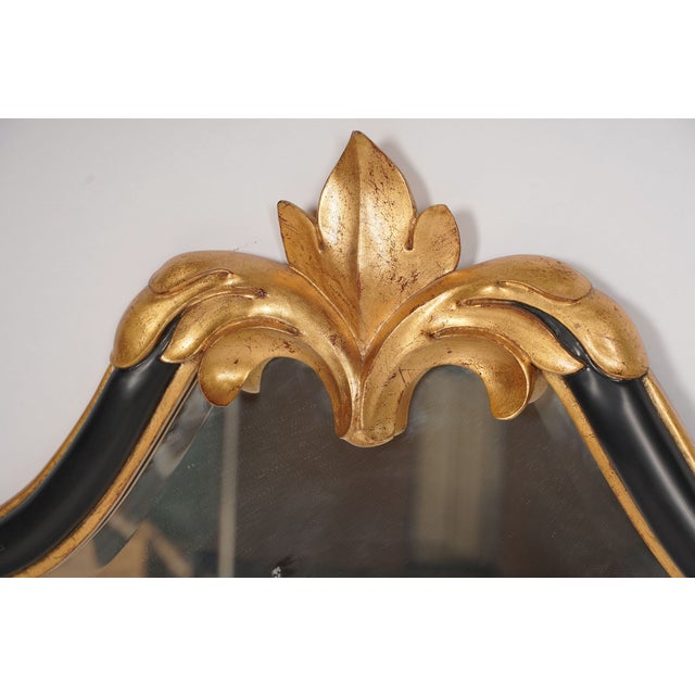 A striking Christopher Guy wall mirror combining sculptural Old World elegance with a bold, sophisticated black-and-gold...