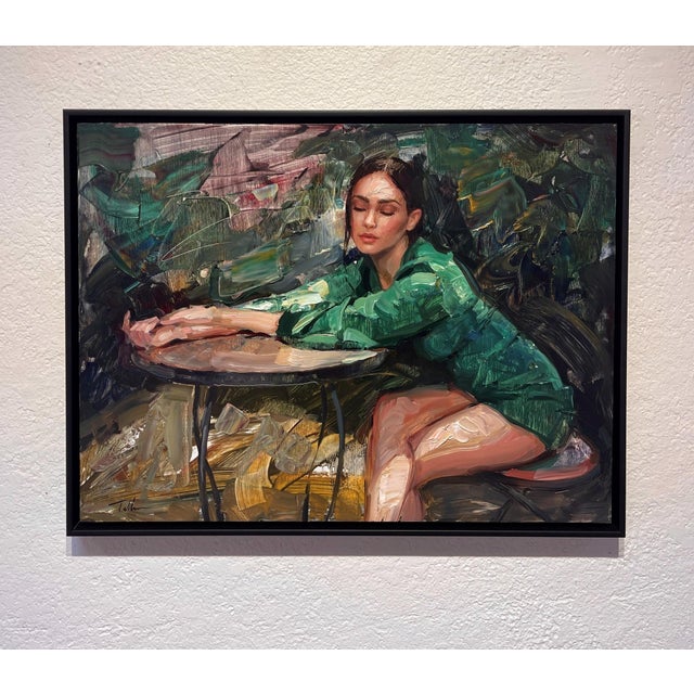 In Repose by Matt Talbert | Oil on panel of a woman sitting at a table in a green outfit For Sale