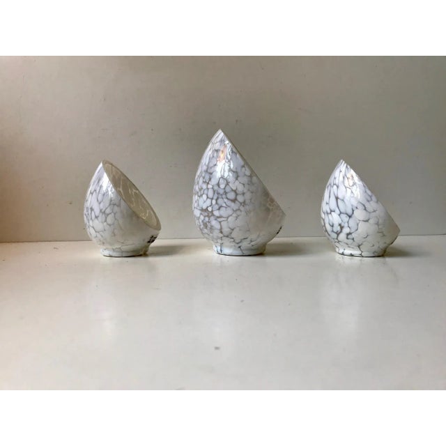 - Half egg shaped candleholders for tealights in white spatter glass - Designed by Swedish design icon Ingegerd Råman and...