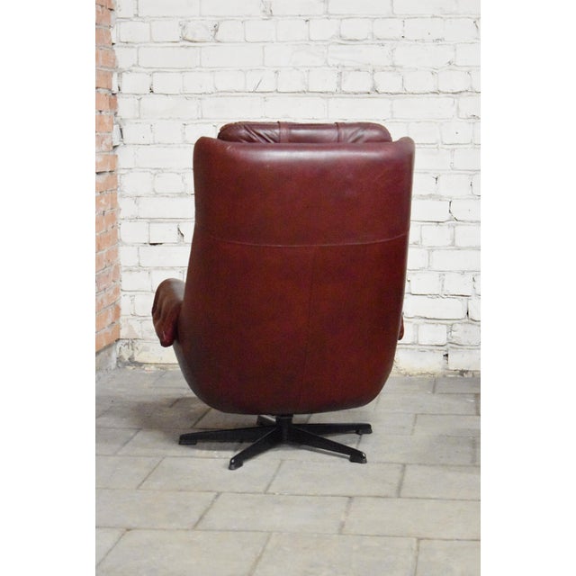 Pair of leather swivel armchairs with ottomans. Remains in great condition. I have official proof of authenticity such as...