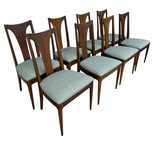 Elevate your dining space with this exceptional set of eight Mid-Century Modern Broyhill Brasilia walnut dining chairs....