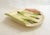 Oval asparagus serving dish with a trompe l'oeil design of folded floral tea towel fabric and asparagus arranged on top;...