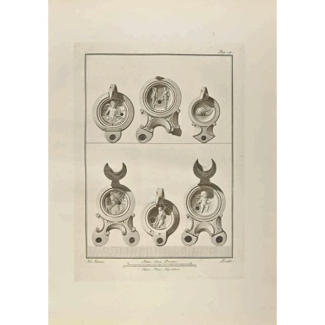 Half Moon Oil Lamps with Cupid and Artemis from "Antiquities of Herculaneum" is an etching on paper realized by Nicola...