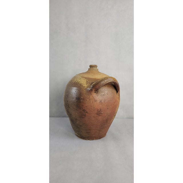 Large Puisaye sandstone jug dating from the 19th century / 2 handles. Height 32 cm Width with handles 30 cm Some oven...