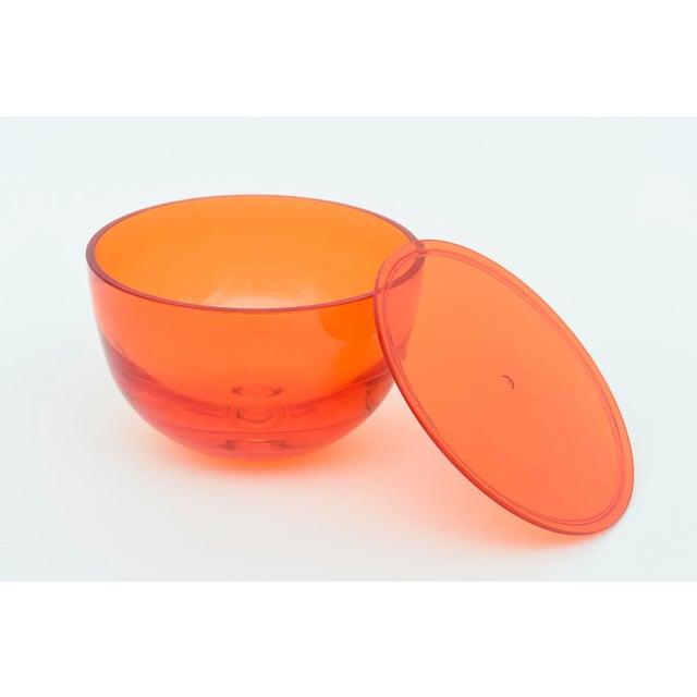 This chic orange round lucite box has a lid that comes off. Great color and great desk accessory. Not sure of its age but...