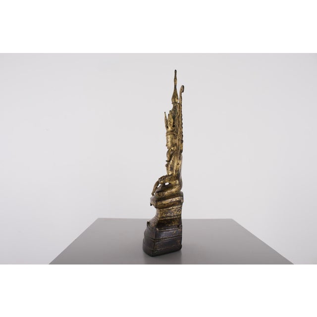 Myanmar, 17th–18th century, gilded bronze Buddha Jambupati. Dimensions: H 26 cm × W 9 cm × D 5.5 cm. Provenance: former...