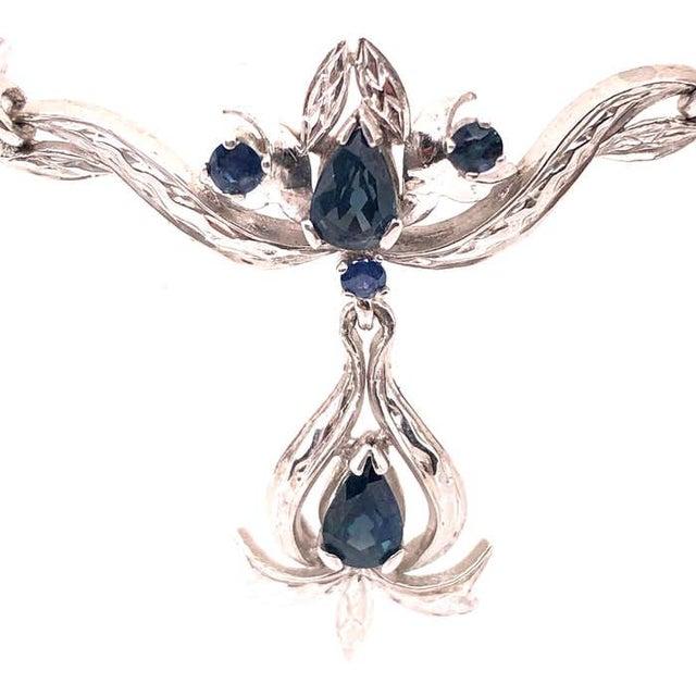 18 Karat White Gold With Blue Sapphire Drop Pendent Necklace. 20 inch Chain Pendant: 10 cm width 3cm height 15.40 grams...