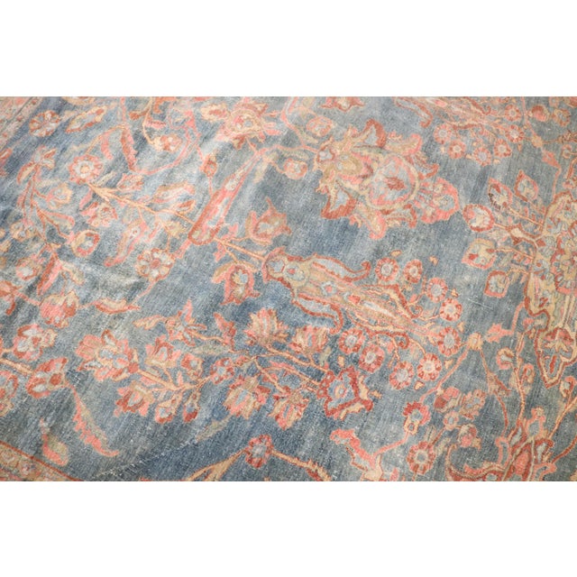 An early 20th-century Persian Sarouk rug. Seafoam Green background with a terracotta border. Pink and turqoise accent...