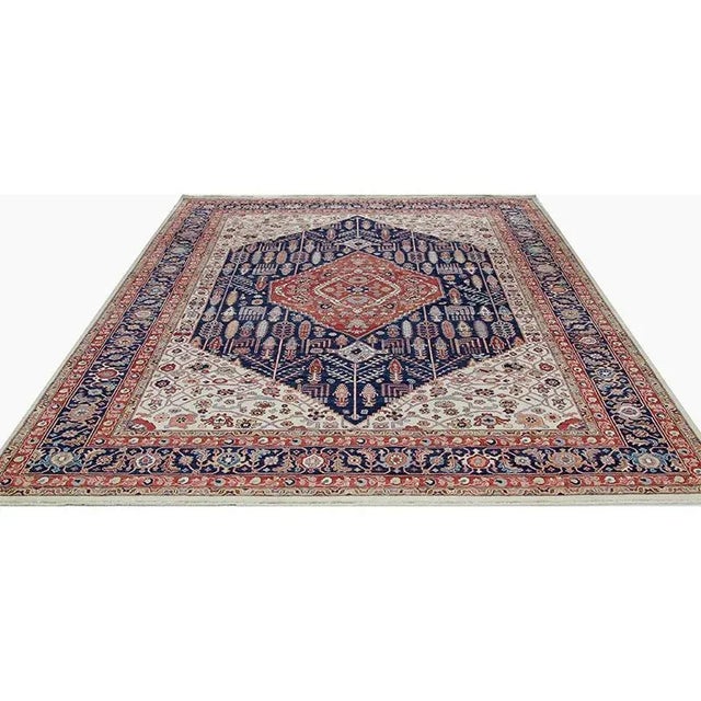 Traditional Handwoven Persian Bakhshayesh Area Rug featuring a medallion and pendants design in a navy-colored field...