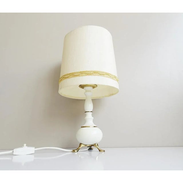 This 1960s table lamp made of metal and brass is a small accent lamp to match the Hollywood Regency style. Ehable design...
