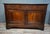 A Louis Philippe period low sideboard in solid walnut, dating from the 19th century. This piece features a simple and...