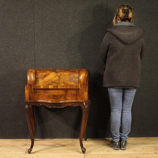 Venetian bureau from the mid-20th century. Furniture finished for the center, carved, veneered, and inlaid in walnut,...