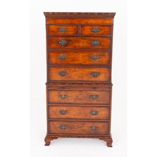 A handsome figured elm chest on chest in the Georgian style, standing on elegant ogee bracket feet The piece is fitted...