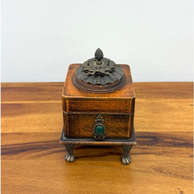 A charming limited edition keepsake box by Jo Marz, crafted from richly finished wood and elevated on ornate metal paw...
