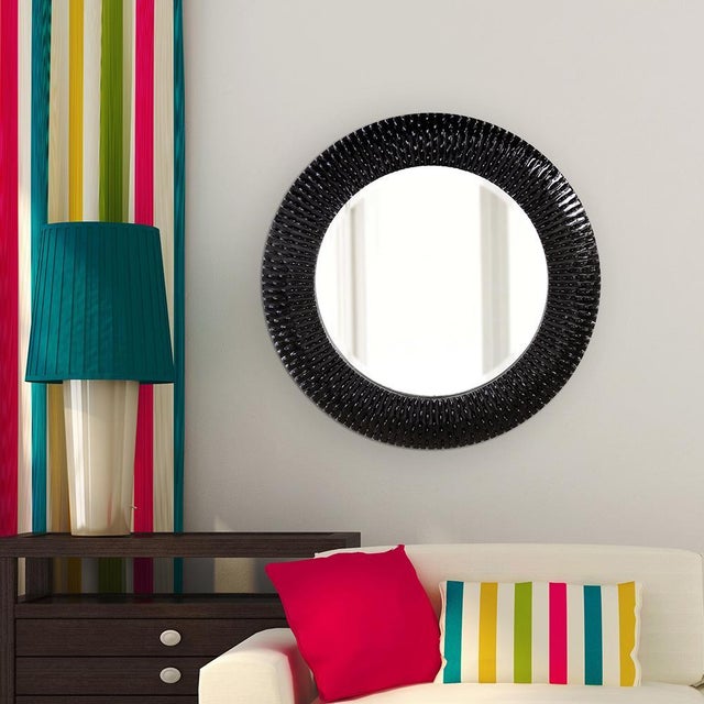 Bergman features a round frame characterized by a textured ribbed frame. It is then painted with our custom glossy black...