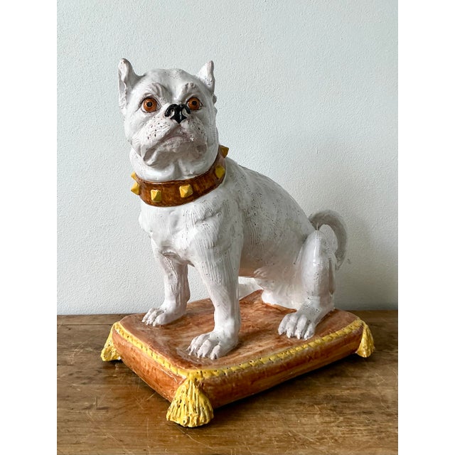 This magnificent vintage Italian majolica sculpture portrays a spirited bulldog seated regally upon a tasseled cushion....