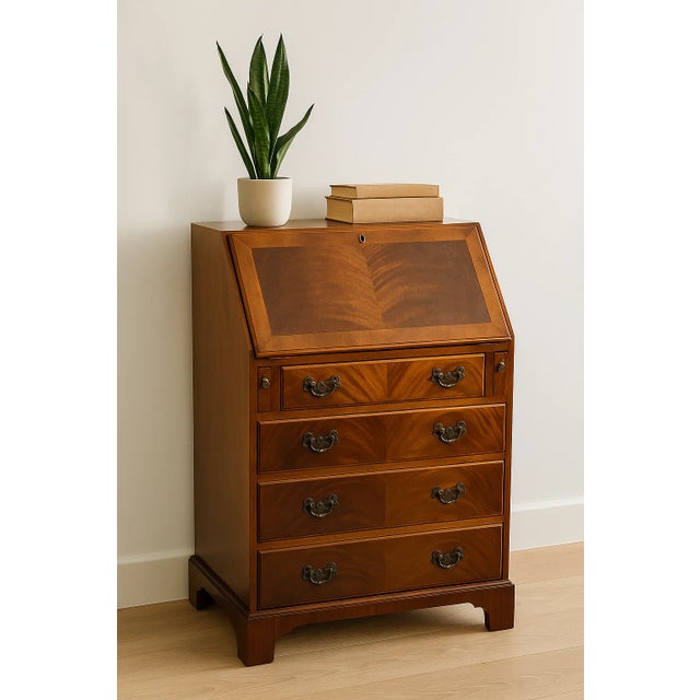 This elegant secretary desk, crafted in mahogany with a striking veneer pattern, was produced by Burton Reproductions...
