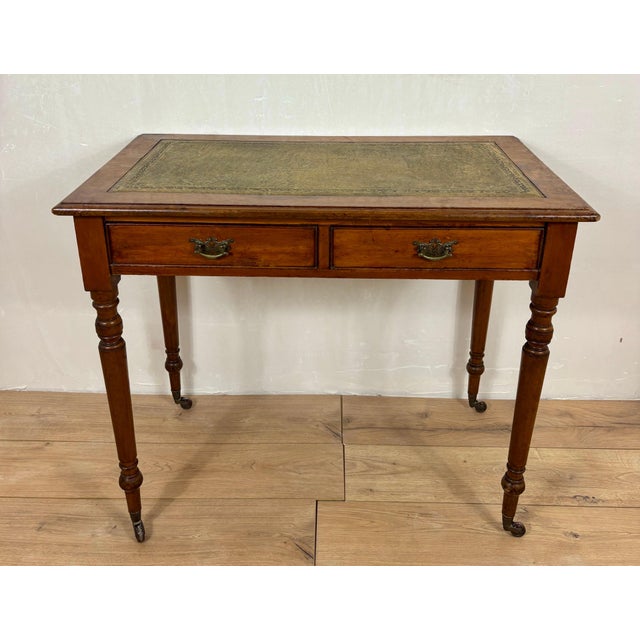 Elegant English Georgian style writing table crafted from solid wood with a warm oak-toned finish. The rectangular top...