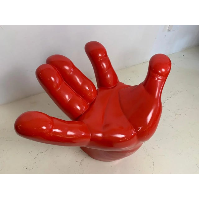 Red Hand chair made of fibreglass.