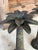 Vintage metal palm tree candle holders in a rustic bronze finish. Great for a coastal table or on a mantle. Please zoom in...