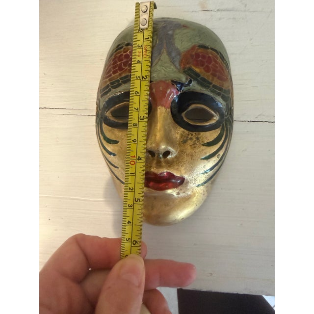 This vintage Venetian/Mardi Gras theatrical mask is crafted from solid brass and decorated with hand-painted colored enamel.