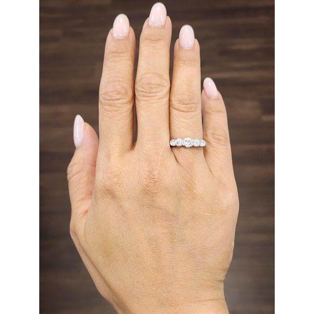 This modern diamond ring is a testament to contemporary elegance. Featuring 5 natural 0.50-carat round-cut diamonds, the...