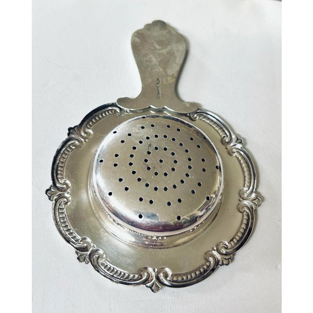 Sterling silver mid century Danish tea strainer that sits on top of a cup while pouring to filter the loose leaves, or...